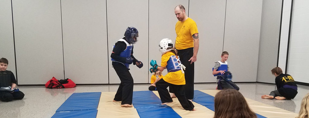 kids practice advanced techniques in karate class
